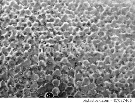 Drop of bee honey drip from hexagonal honeycombs 87027406