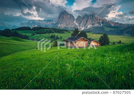 Wooden huts on the slope in the Dolomites, Italy Wooden huts on the slope in the Dolomites, Italy 87027505