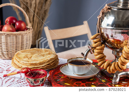 Russian pancakes blini with samovar tea cup and drying on the table Russian pancakes blini with samovar tea cup and drying on the table 87028021