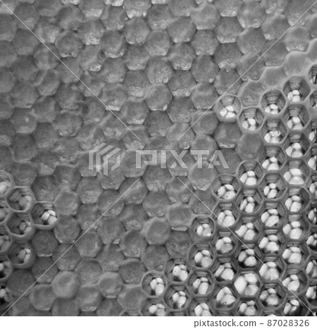 Drop of bee honey drip from hexagonal honeycombs Drop of bee honey drip from hexagonal honeycombs 87028326