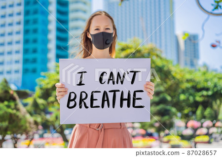 Woman holds a poster with an inscription - i can't breathe Woman holds a poster with an inscription - i can't breathe 87028657