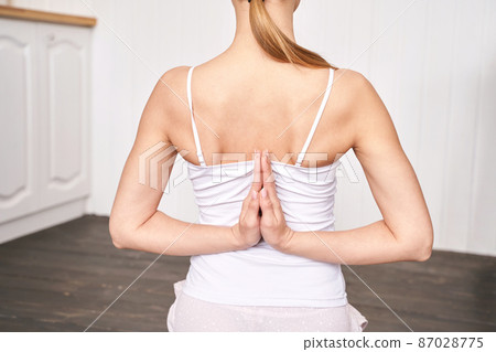 Young woman going yoga exercise at home. Health care online lessons. Indoor 87028775