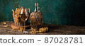 A glass of homemade white wine with grapes and a bottle on a rustic wooden table 87028781