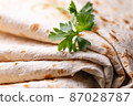 Lavash rolled on a wooden background, thin traditional oriental bread, Armenian flatbread macro 87028787