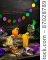 Alcoholic cocktails, Mardi Gras decoration on dark background 87028789