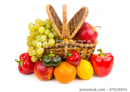 Fruits and vegetables in a basket isolated on a white . 87029854
