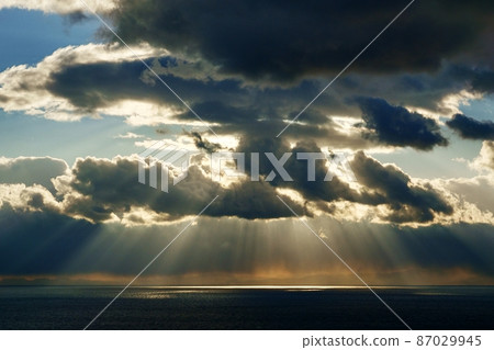 Dynamic light beam created by winter sky and sea, afternoon sun and clouds 87029945