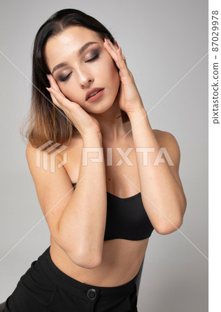 Dark hair young woman on grey 87029978