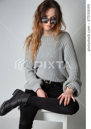 Woman in grey jumper on grey 87030099
