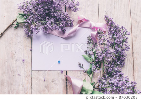 Spring flowers. Lilac flowers on white wooden background. Top view, flat lay with copy space 87030205