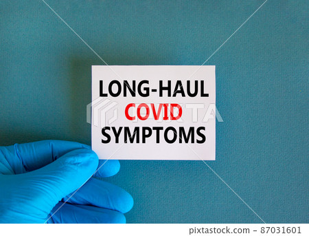 COVID-19 long-haul covid symptoms symbol. White card with words Long-haul covid symptoms. Doctor hand, blue background, copy space. Medical, COVID-19 long-haul covid symptoms concept. COVID-19 long-haul covid symptoms symbol. White card with words Long-haul covid symptoms. Doctor hand, blue background, copy space. Medical, COVID-19 long-haul covid symptoms concept. 87031601