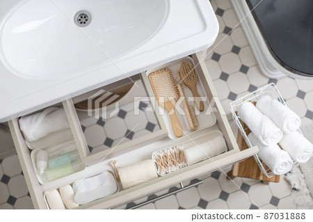 Marie Kondo's method organization of bathroom amenities. Tidying up or storage household space Marie Kondo's method organization of bathroom amenities. Tidying up or storage household space 87031888