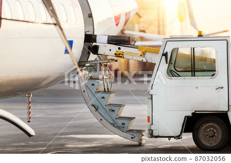 Close-up detail view of belt loading machine car load commercial parcel shipment in small cargo plane compartment. Air mail shipping and logistics service . Commercial charter flight service Close-up detail view of belt loading machine car load commercial parcel shipment in small cargo plane compartment. Air mail shipping and logistics service . Commercial charter flight service 87032056