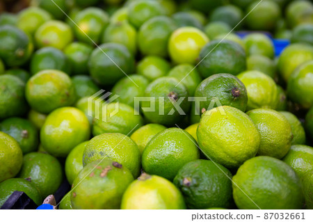 Fresh limes displayed for sale at greengrocery 87032661