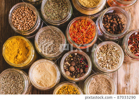 Various colorful kinds of spices on rustic wooden table, top view Various colorful kinds of spices on rustic wooden table, top view 87033290