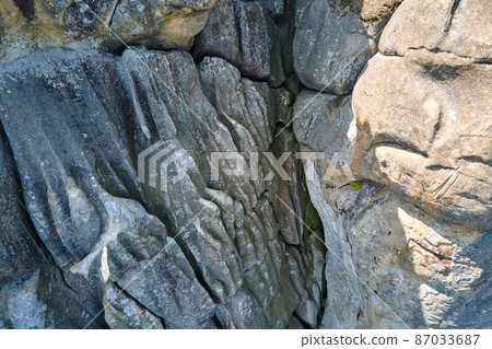 Aerial view of large rocky formations with snone boulders and mountain high cliffs Aerial view of large rocky formations with snone boulders and mountain high cliffs 87033687