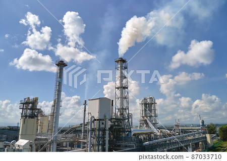 Aerial view of factory with high plant manufacture structure. Global production and manufacturing concept. Aerial view of factory with high plant manufacture structure. Global production and manufacturing concept. 87033710