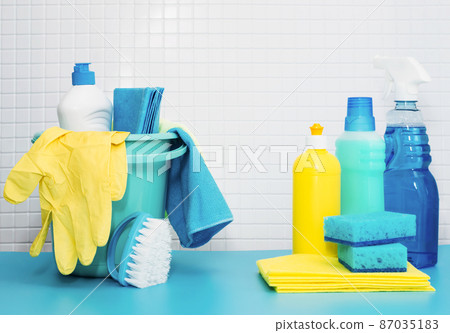 Set of cleaners and detergents, cleaning accessories, blue background with tiles. Concept spring regular cleaning 87035183