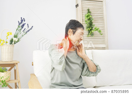 Elderly female stiff shoulder living room Elderly female stiff shoulder living room 87035895
