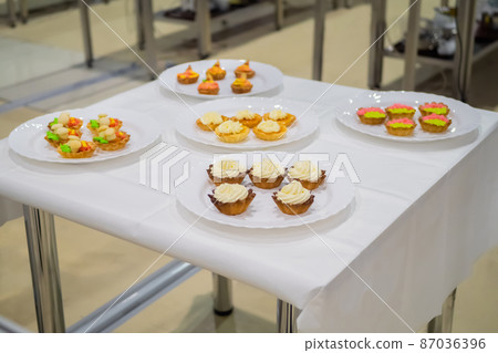 Fresh shortcrust tart cakes with cream on white plate for sale Fresh shortcrust tart cakes with cream on white plate for sale 87036396