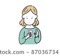 Woman using a smartphone 87036734