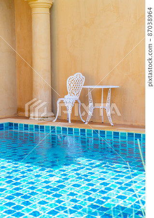 white chair and table on side the swimming pool 87038964