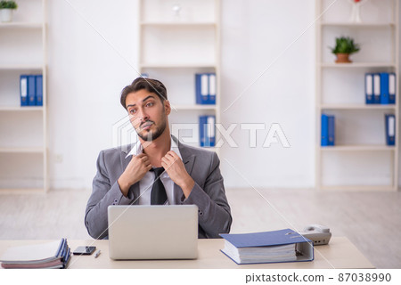 Young male employee working in the office 87038990