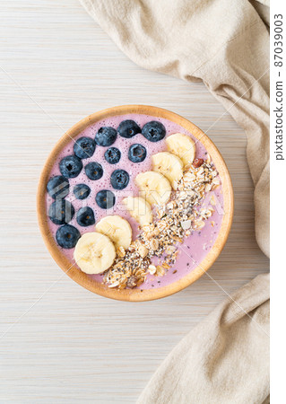 yogurt or yoghurt smoothie bowl with blue berry, banana and granola 87039003