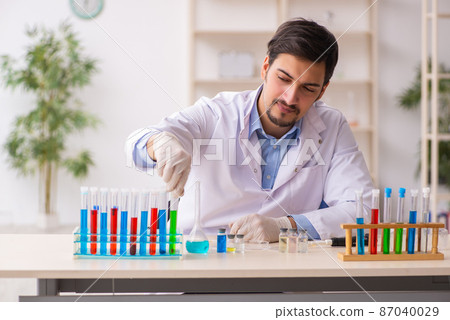 Young male chemist working at the lab Young male chemist working at the lab 87040029