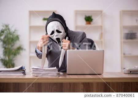 Devil businessman employee sitting at workplace Devil businessman employee sitting at workplace 87040061