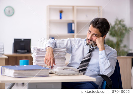 Young male employee working in the office Young male employee working in the office 87040065