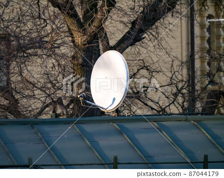 Satellite dish on the roof of the house. 87044179