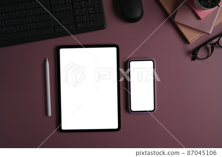 Mockup digital tablet and smart phone with blank screen on purple background. Mockup digital tablet and smart phone with blank screen on purple background. 87045106
