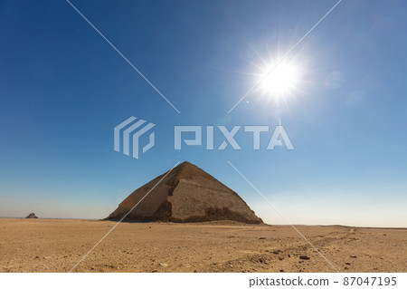 Beauty of one pyramid with sun on the blue sky. Beauty of one pyramid with sun on the blue sky. 87047195