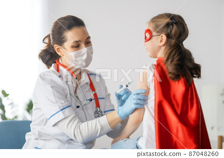 Doctor vaccinating child Doctor vaccinating child 87048260