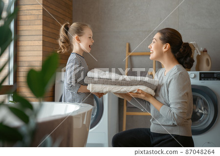 family doing laundry family doing laundry 87048264