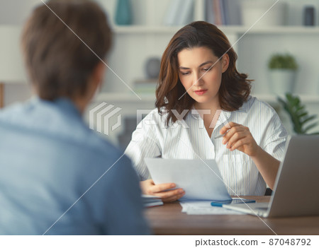Man and woman are working in office Man and woman are working in office 87048792