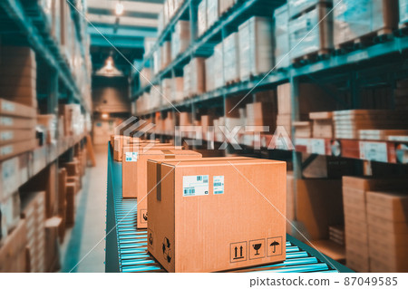 parcels on conveyor belt in a warehouse. 87049585
