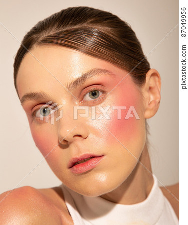 European woman with pastel flowers isolated on light beige European woman with pastel flowers isolated on light beige 87049956