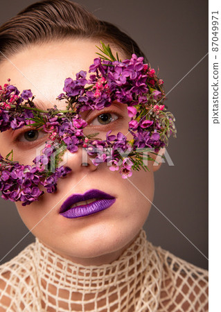 Woman with eye flower mask portrait Woman with eye flower mask portrait 87049971