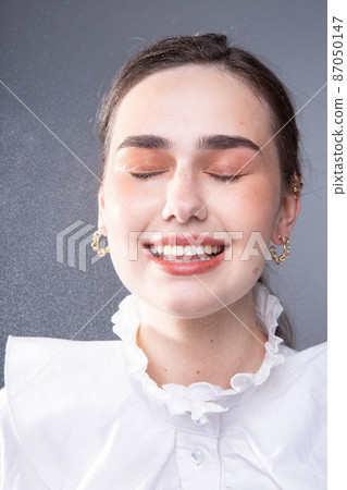 Young woman in office blouse closeup portrait Young woman in office blouse closeup portrait 87050147