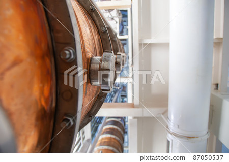 Copper still alembic inside distillery to distill grapes and produce spirits Copper still alembic inside distillery to distill grapes and produce spirits 87050537