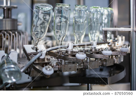 The machine for washing glass bottles. Factory for bottling alcoholic beverages. 87050560