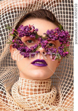 Woman with eye flower mask portrait Woman with eye flower mask portrait 87050710