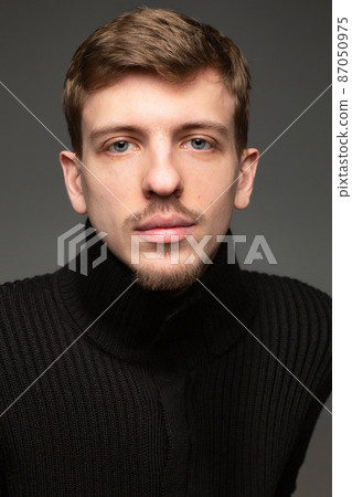 Blond man in black isolated on black Blond man in black isolated on black 87050975