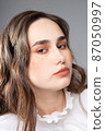 Young woman in office blouse on grey 87050997