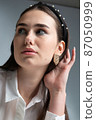 Young woman in office blouse on grey 87050999