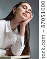 Young woman in office blouse on grey 87051000