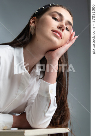 Young woman in office blouse on grey 87051000