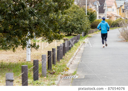 Senior man jogging as a hobby Senior man jogging as a hobby 87054076